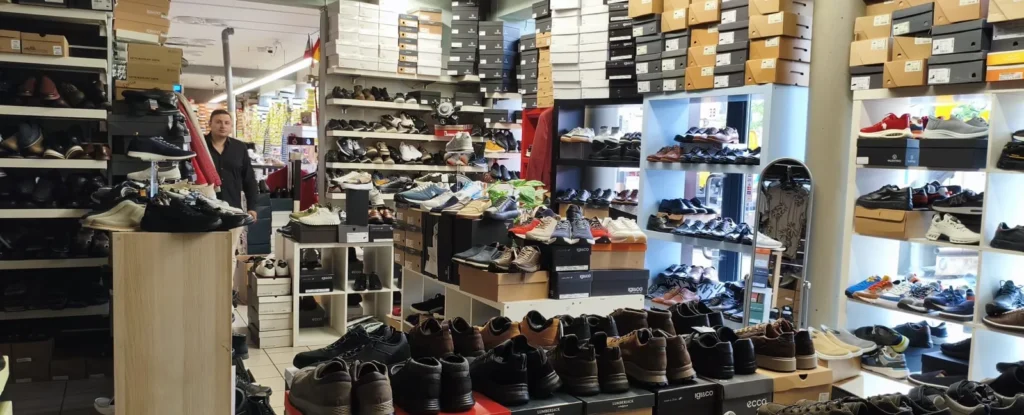 Shelves stacked to the ceiling with shoe boxes at Outlet Chaussures Bruxelles on Place du Jeu de Balle, Brussels